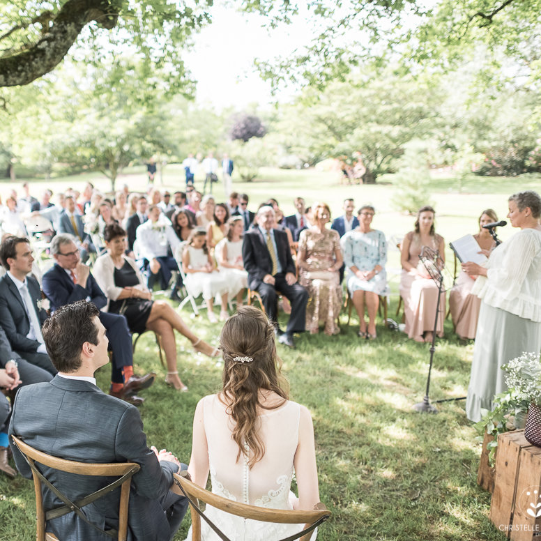 Bilingual wedding ceremony in France under oak trees with bridal party